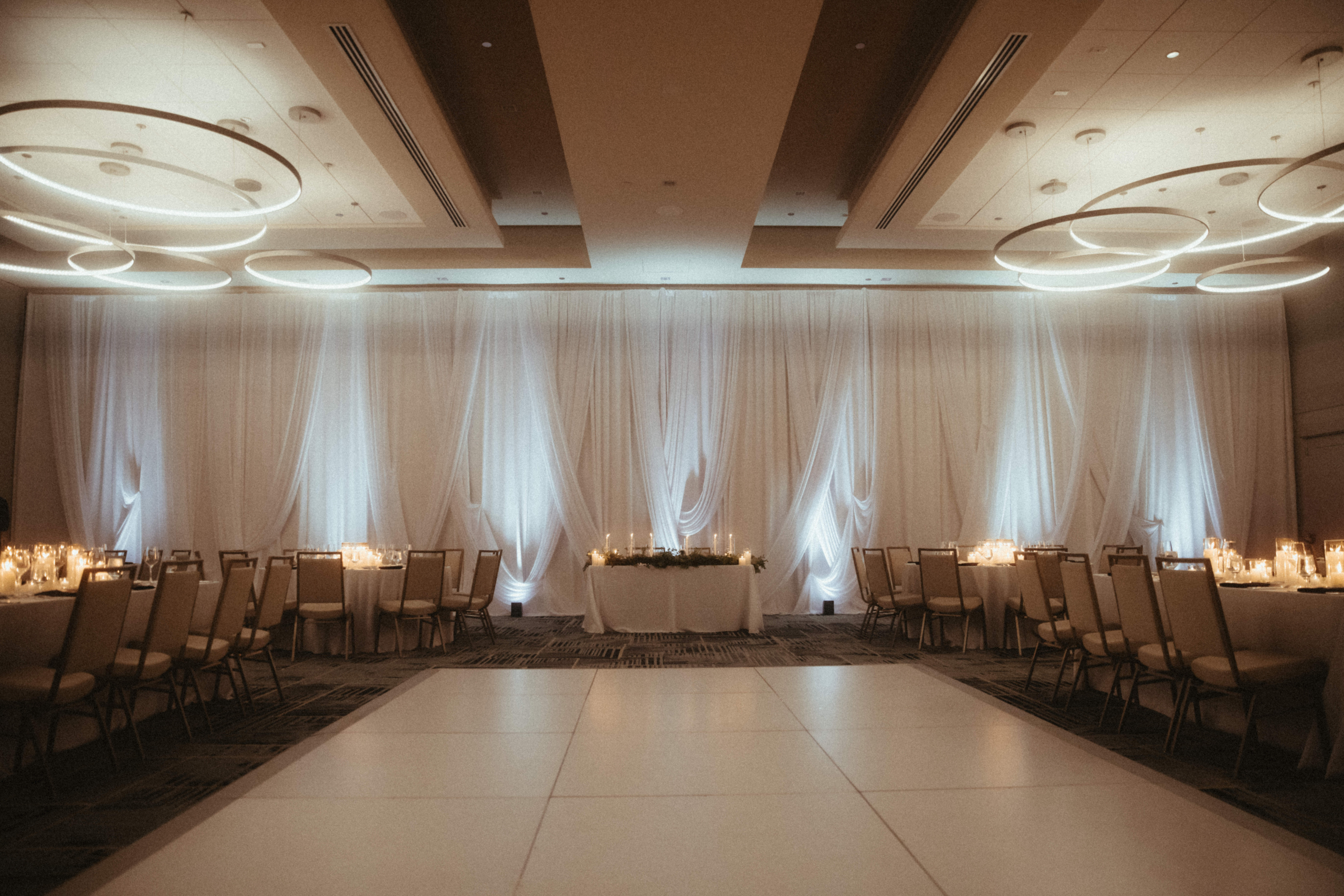 custom wedding drape backdrop at Biltmore Golf Club in Arizona featuring white uplighting