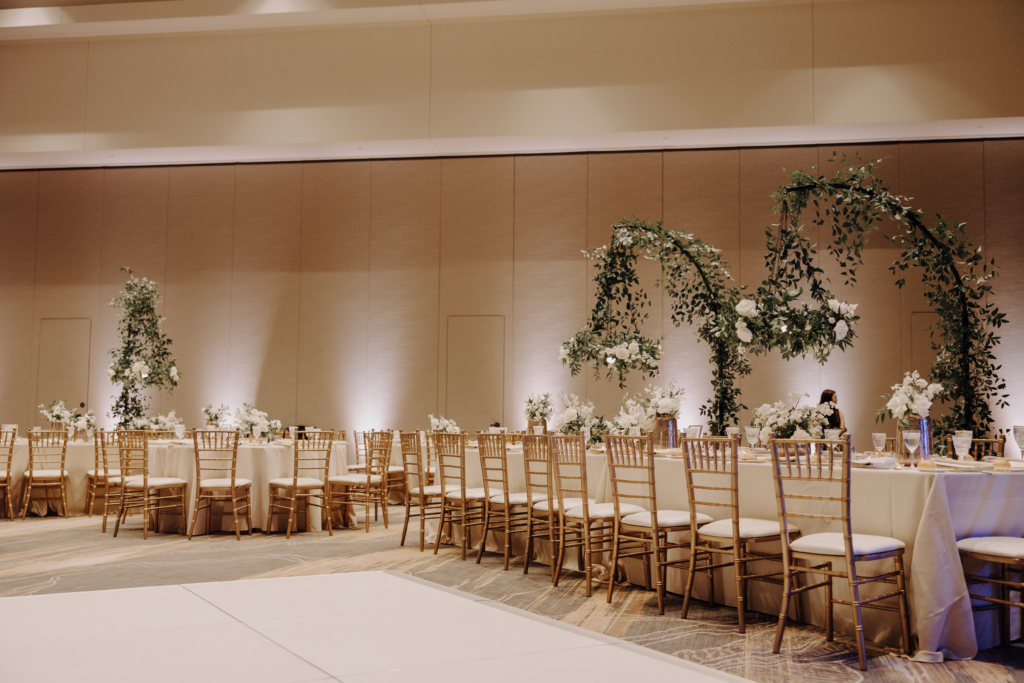 wedding featuring chandeliers on shepherd hooks and white uplighting