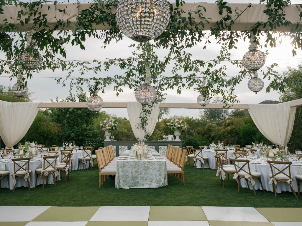 luxury wedding at Paradise Valley Country Club featuring custom drape, custom truss structure, and chandelier installation by Centric Events and Rentals