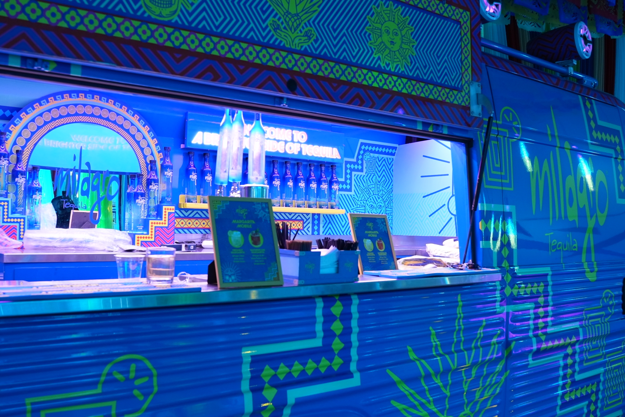 Milagro Tequila brand activation featuring custom lighting and bus serving alcohol