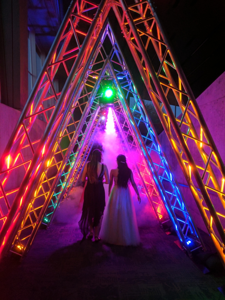 custom event entrance with trussing, colored lighting and fog machine 