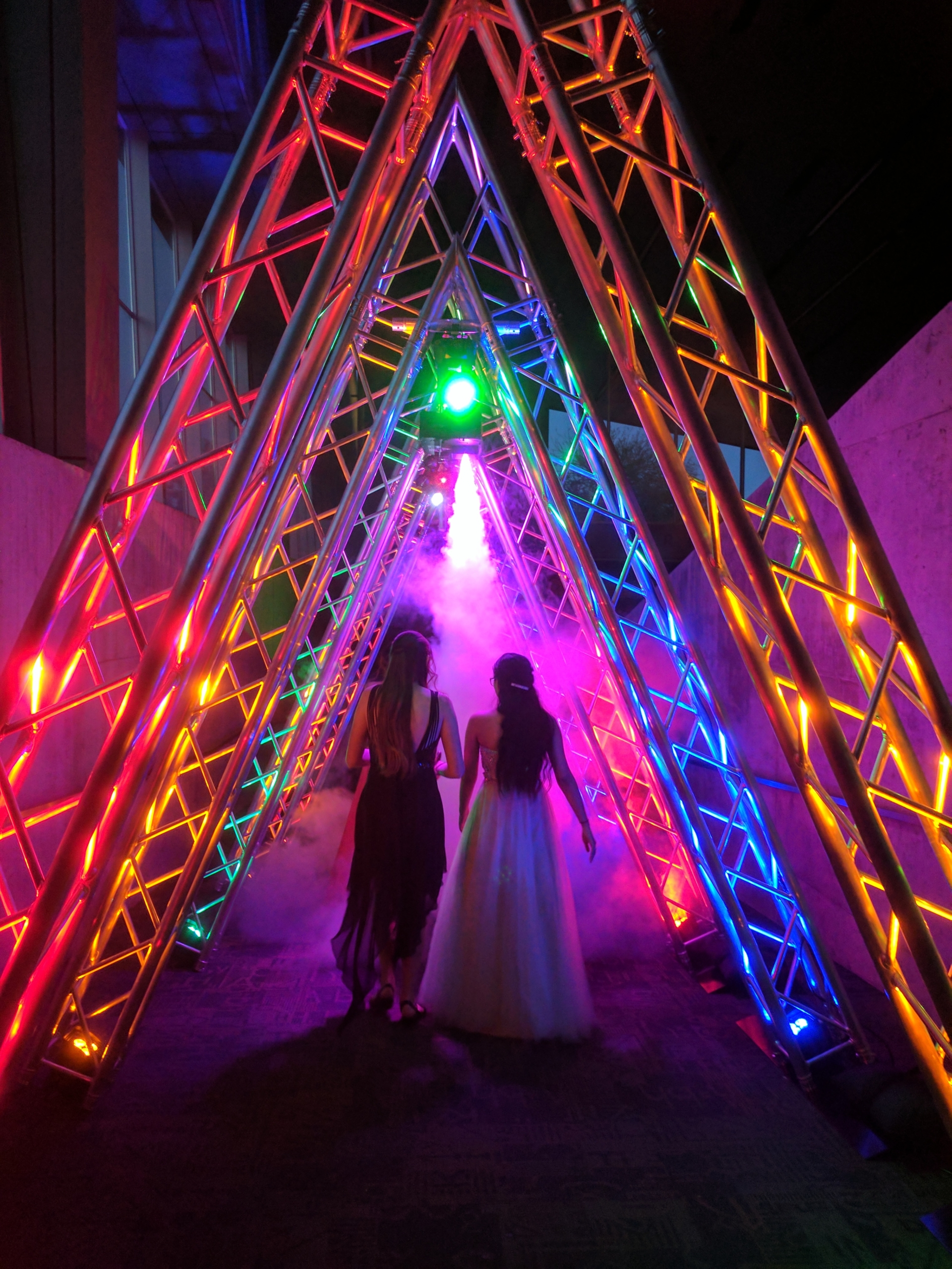 custom event entrance with trussing, colored lighting and fog machine