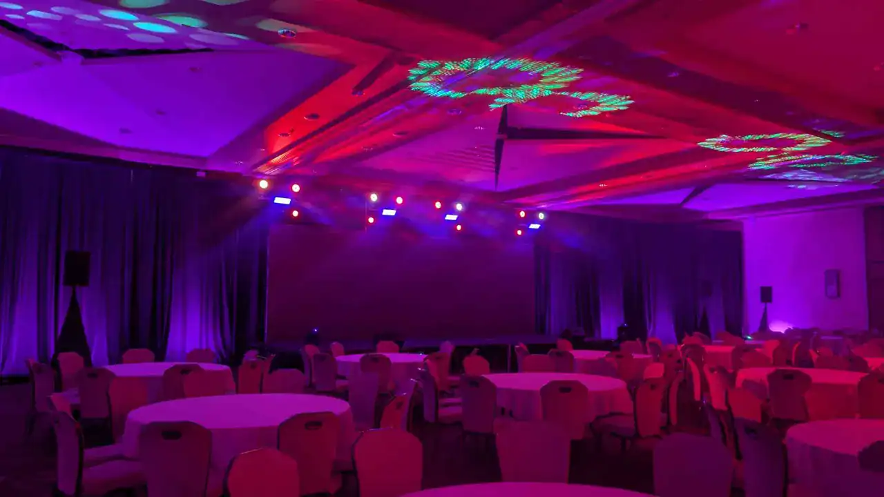 Intelligent moving head lighting and high-energy atmospherics on a corporate event stage in Tempe, Arizona.